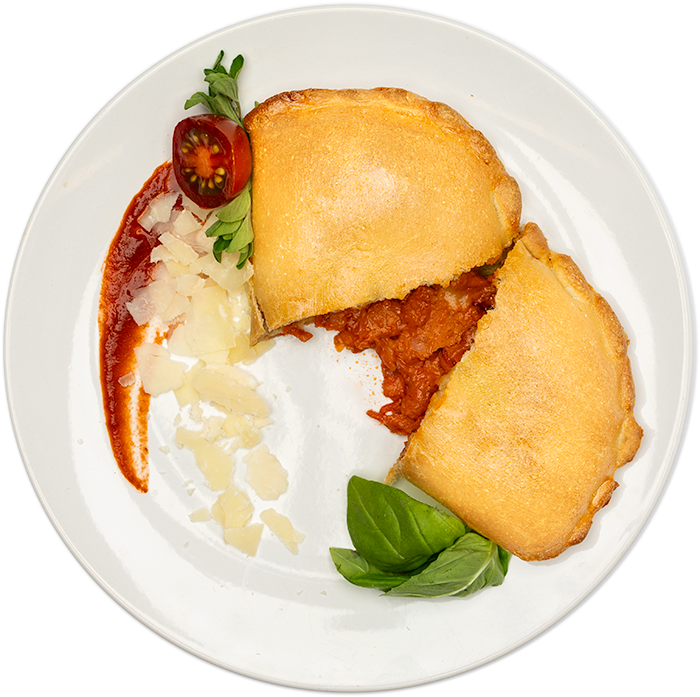 Image of the Turkey Pepperoni calzone product on a plate, with other assorted foods